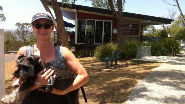 Sue Hinds and pooch in front of the cafe.