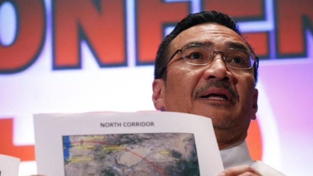 Hishamuddin Hussein shows maps during a press conference near Kuala Lumpur.