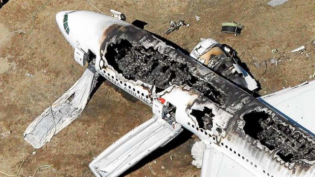The Asiana Airlines airplane lies burned near the runway after it crash-landed at San Francisco International Airport on July 6.
