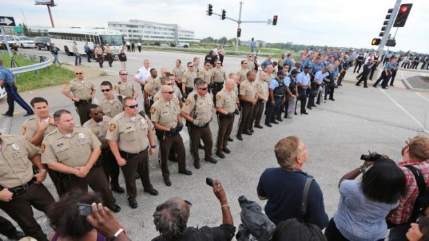 Police form a line as protesters try to shut down Interstate 70 in Berkeley, Missouri on Wednesday.