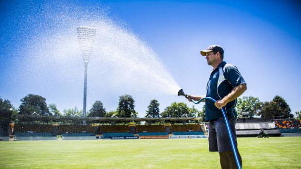 Brad Bandam, Head curator at Manuka Oval waters the pitch before the PM's XI.