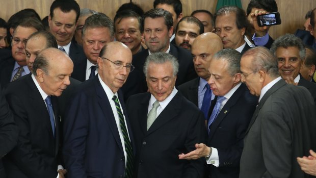 Brazilian acting President Michel Temer swears in his new ministry with Jose Serra (far left, front).