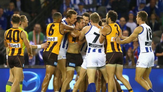 Players wrestle after a high hit by Hawthorn's Luke Hodge on Andrew Swallow of the Kangaroos.