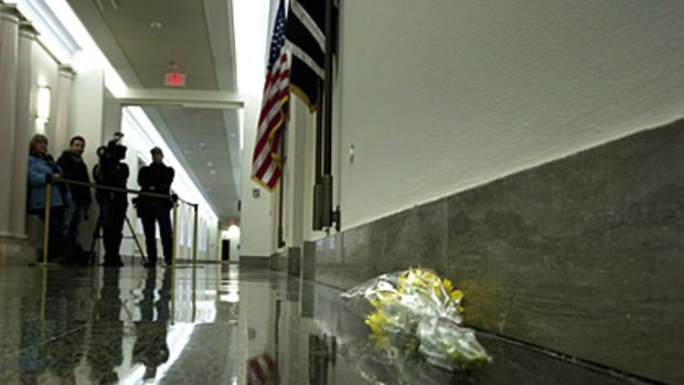 Flowers lie outside the office of Gabrielle Giffords in the Longworth House Office Building on Capitol Hill in Washington, DC.