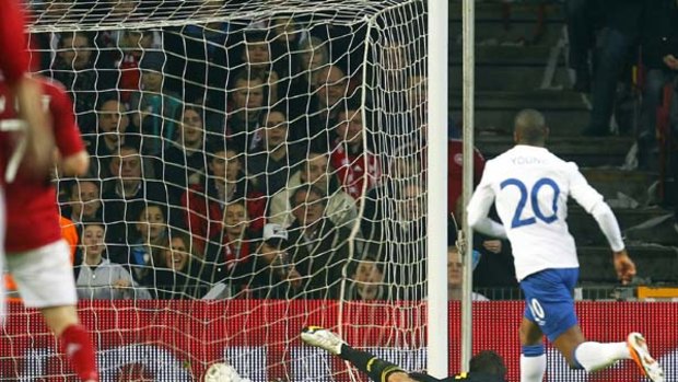 Ashley Young of England scores the winning goal past Denmark's goalkeeper Thomas Soerensen.