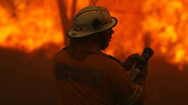 Fire fighters work to protect houses in Wyee Point.