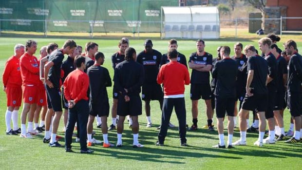 England players listen to coach Fabio Capello, centre, during a training session on Monday.
