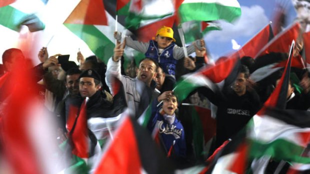 Palestinians celebrate the vote in the West Bank city of Ramallah.