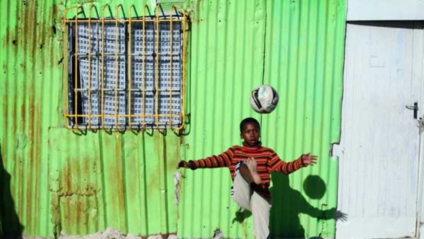 A child plays football in Khayelitsha township, Cape Town.