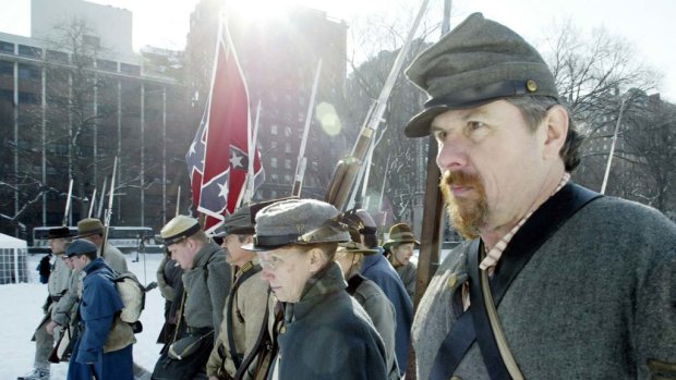Men dressed as Confederate soldiers re-enact a Civil War battle in New York.