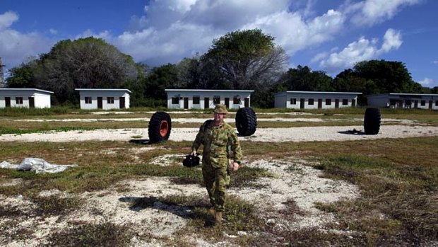 Rundown &#8230; an Australian Defence Force photographer assesses one of the detention centre buildings at Nauru.