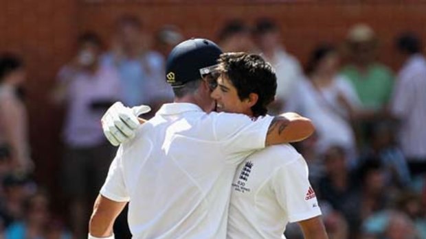 He's done it ... Kevin Pietersen congratulates Alastair Cook on his century at Adelaide Oval yesterday.