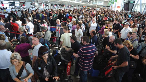 Travellers queue at Sydney Airport.