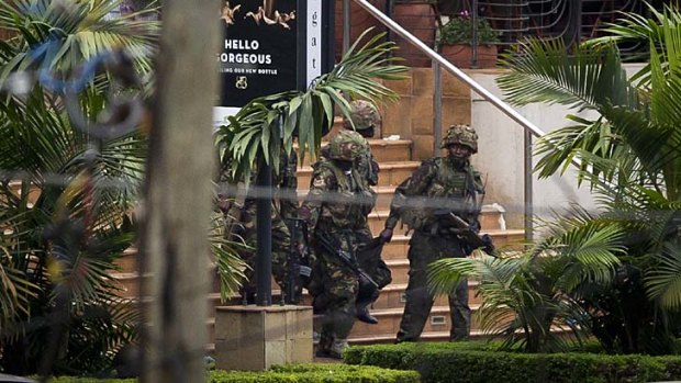 Soldiers from the Kenya Defence Forces carry a wounded colleague out of the Westgate Mall.