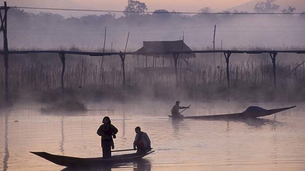 Still life... villagers on Inle Lake in the morning mist.