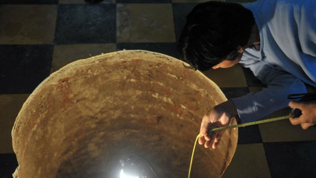 Mind the gap ... a man inspects a sinkhole inside a house in Guatemala City.