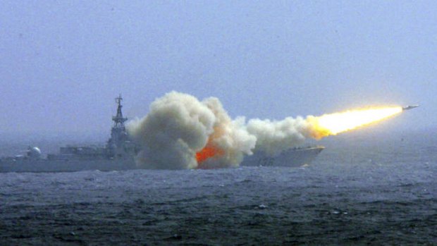 Fire power: A Chinese warship fires a missile during a training exercise in the South China Sea.