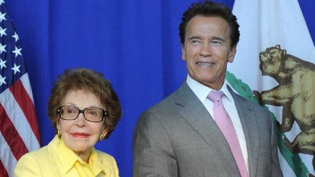 Economic strife ... Arnold Schwarzenegger, pictured here with Nancy Reagan on Wednesday,  is forcing state workers in California to take leave.