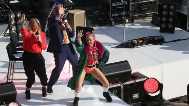 Miley Cyrus performs with Sunrise hosts Samantha Armytage and David Koch on Sunrise at the Sydney Opera House.