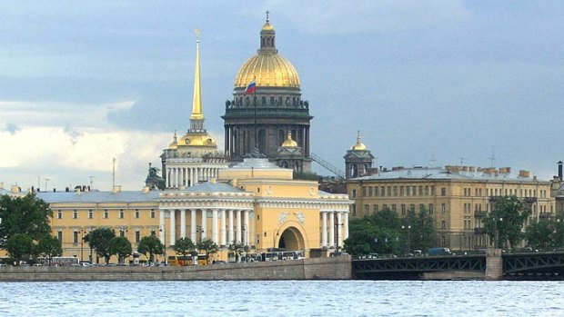 A boat passes in front of the St Isaak Cathedral in the historical centre of St. Petersburg.