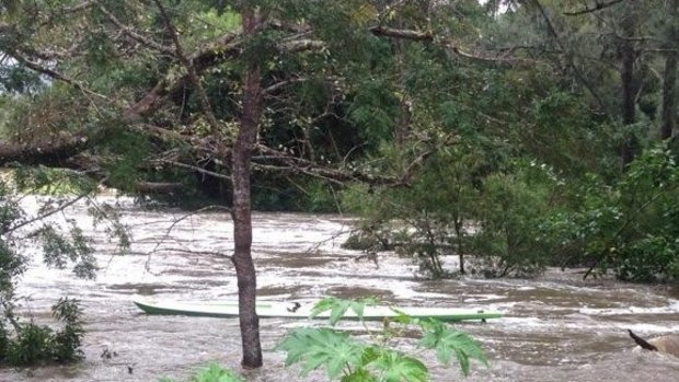 Police want to track down the owner of this canoe, seen in floodwater near Guanaba in the Gold Coast hinterland.