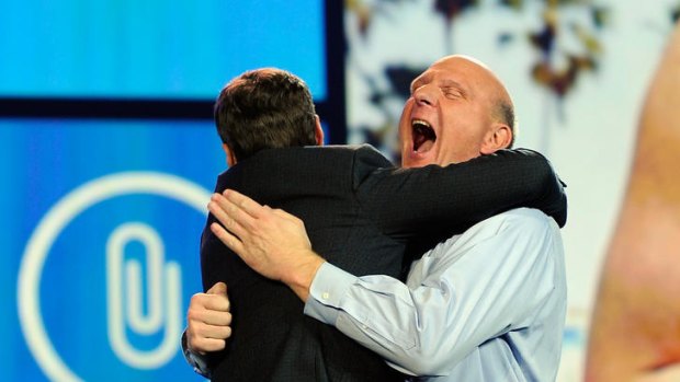 icrosoft CEO Steve Ballmer hugs host Ryan Seacrest.