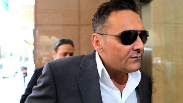 Dark glasses all round: George Alex arrives at the royal commission on Friday. 