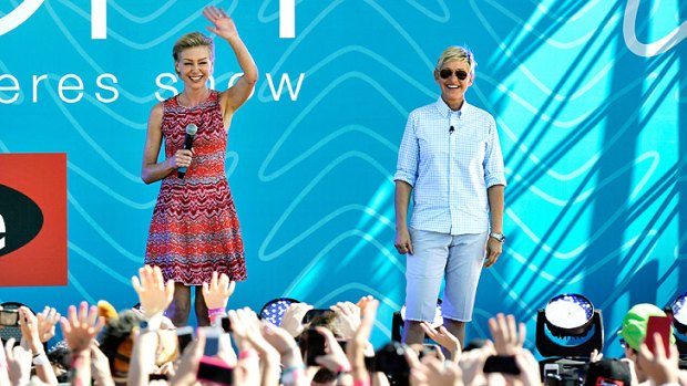 Ellen DeGeneres, right, with wife Portia de Rossi greet the large crowd at Birrarung Marr in Melbourne.