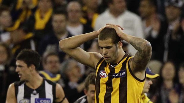 Hurting Hawk: A shattered Lance Franklin trudges off the MCG after Hawthorn's three-point loss to the Magpies on Friday night.