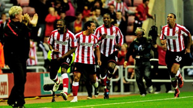 The Sunderland players react after their late equaliser against Arsenal.
