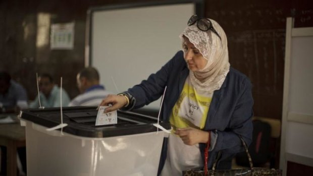 An Egyptian woman casts her vote at a polling site in the upscale Zamalek district of Cairo.