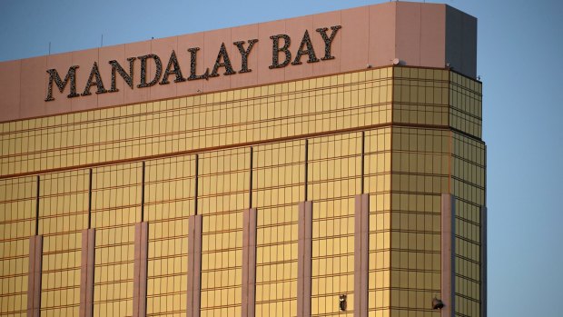 Drapes billow out of broken windows at the Mandalay Bay resort and casino Monday, Oct. 2, 2017, on the Las Vegas Strip following a deadly shooting at a music festival in Las Vegas.
