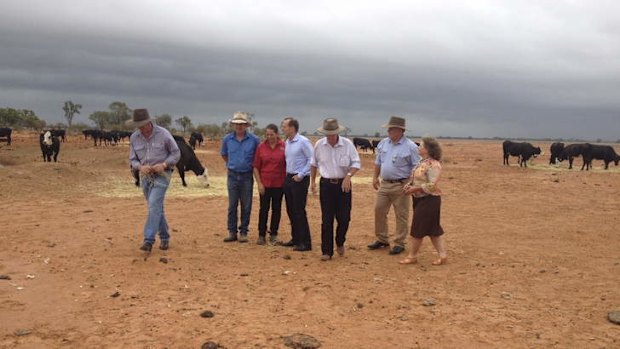 Prime Minister Tony Abbott, centre, visits Bourke as rain starts to fall.