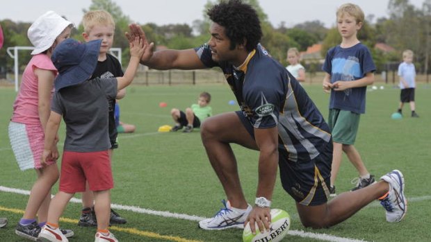 Brumbies winger Henry Speight at a junior rugby development event at Gold Creek Primary School on Friday.