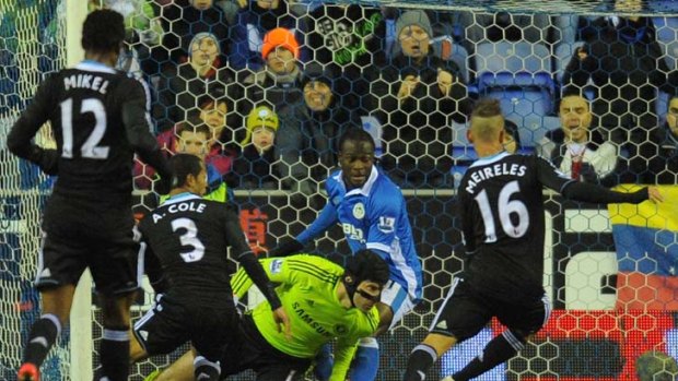 Late heartbreak &#8230; Chelsea goalkeeper Petr Cech's save goes straight to Jordi Gomez, leading to Wigan's late equaliser at the DW Stadium. Photos: AFP, Getty Images
