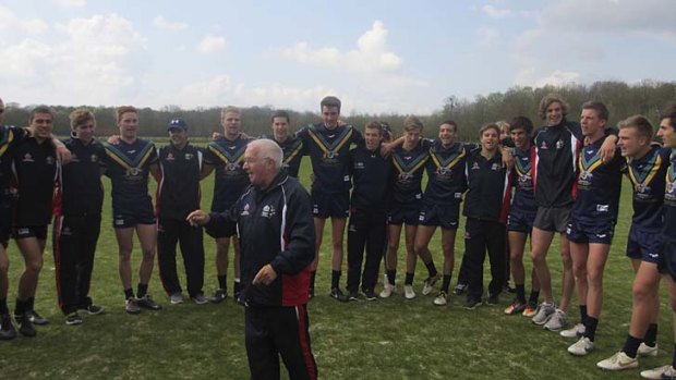 Learning leadership: The AIS-AFL Academy squad team link arms as retiring trainer John Wassell leads a victory song after beating the European Titans in Chantilly, France.