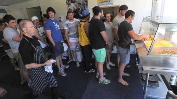 Players line up for lunch at Brumbies HQ as chef Brian Gibson makes sure everything is in order.