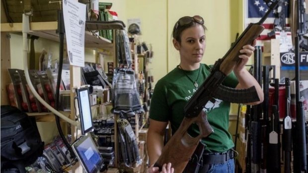 Tracy Earlenbaugh shows a Russian AK-47 at TW Firearms in Leesburg, Virginia on August 22. After the Obama administration added the machine gun to sanctions against Russia for its actions in Ukraine, gun dealers reported a massive jump in sales of the weapon.