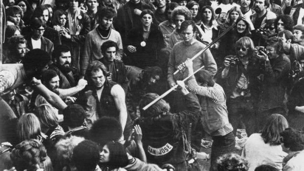 A fan is beaten by Hells Angels at the Rolling Stones' free concert at Altamont Speedway. The rock press called it the end of innocence.