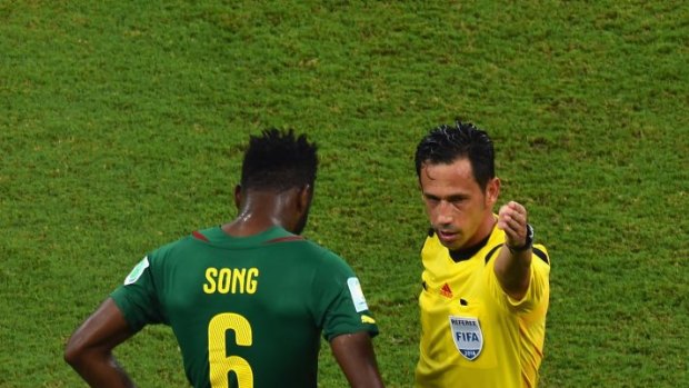 Alex Song of Cameroon is sent off after a red card by referee Pedro Proenca for elbowing an opponent from Croatia.
