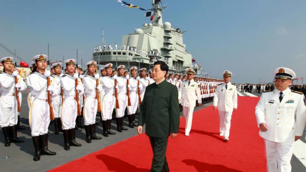 Naval power ... the Chinese President, Hu Jintao, inspects the guard of honour at the launch of the aircraft carrier Liaoning.