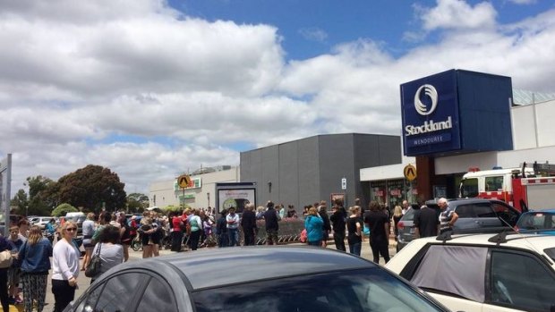 Shoppers crowd the car park at Stockland Wendouree after a fire on Friday afternoon. 