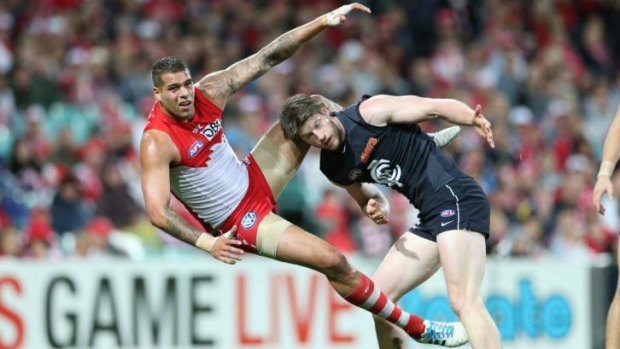 Oops: Sydney forward Lance Franklin gets tangled with Carlton's Sam Rowe.
