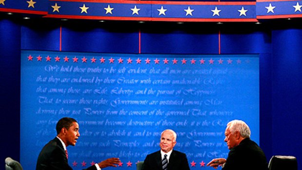 Barack Obama (left) answers a question from moderator Bob Schieffer (right), while John McCain (middle) listens.