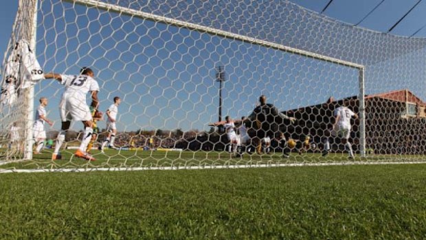 Full stretch ... the Americans manned their posts, but were still unable to prevent Tim Cahill sliding in at the far post to score for the Socceroos. The goal levelled the scores before the US struck twice to win 3-1.