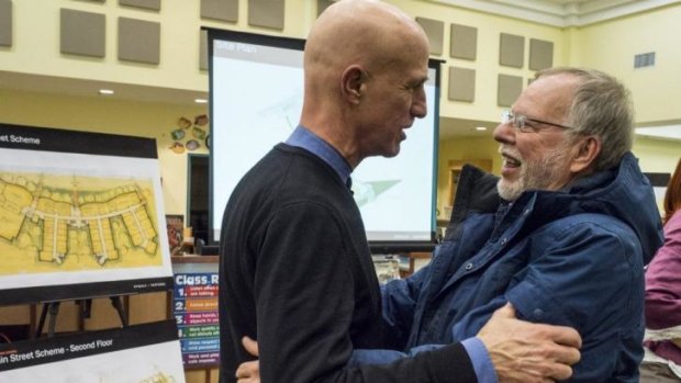 Architect Barry Svigals greets Gene Rosen, a Sandy Hook resident who sheltered fleeing children on the day of the massacre.