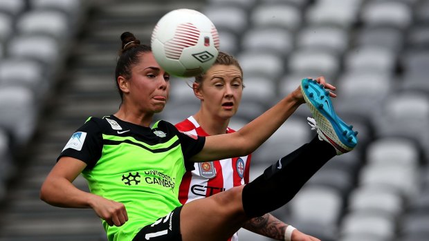 Emma Checker of Canberra contests the ball against Larissa Crummer of Melbourne City.
