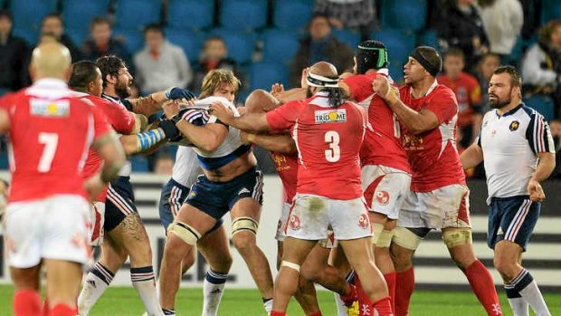 Brutal brawl: France's lock Yoann Maestri (C) fights with Tonga's players.