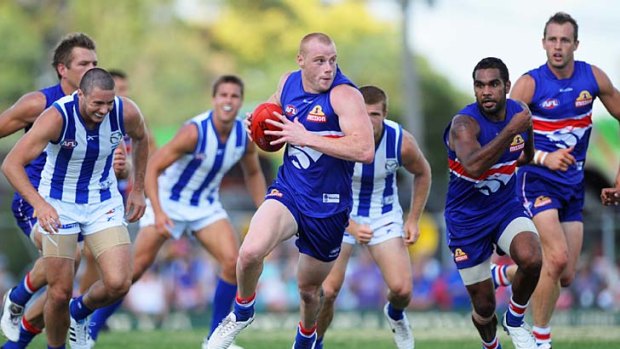 A sight to strike fear into North Melbourne: Adam Cooney in pack-bursting full-flight.
