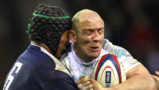 Heavy clash . . .  Mike Tindall of England is tackled by  Thierry Dusautoir of France.